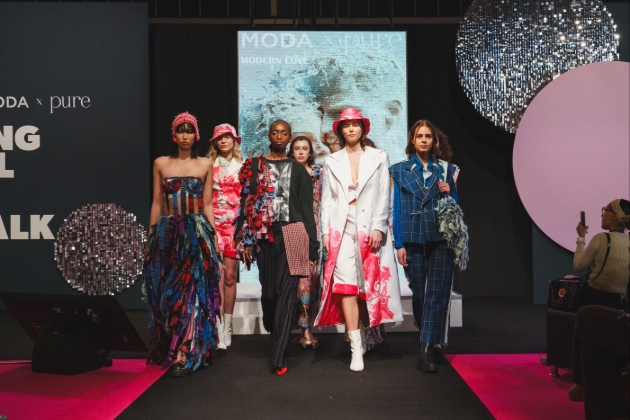 Six ladies walking down a catwalk